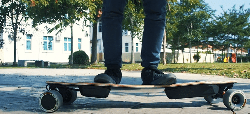 Boy standing on Backfire G2 Galaxy Electric Skateboard
