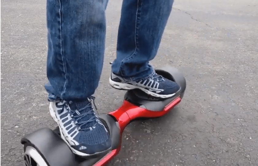 person riding SWAGTRON T580 App-Enabled Hoverboard