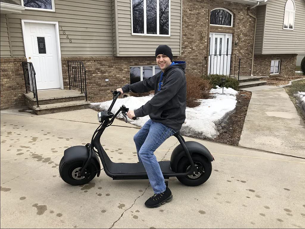 guy riding Toxozers Fat Tire 2000W Electric Scooter