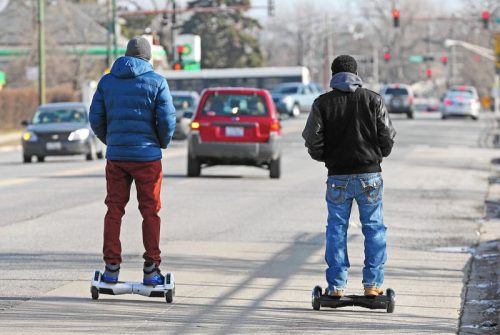 two men riding hoverboard