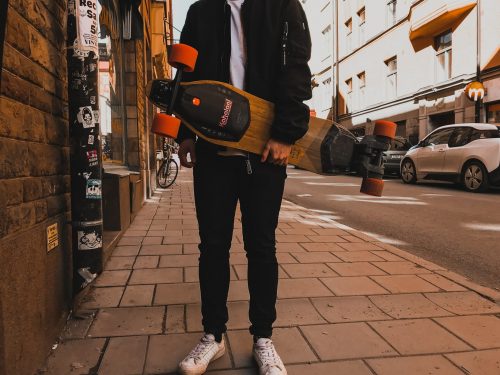 electric skateboard held by rider