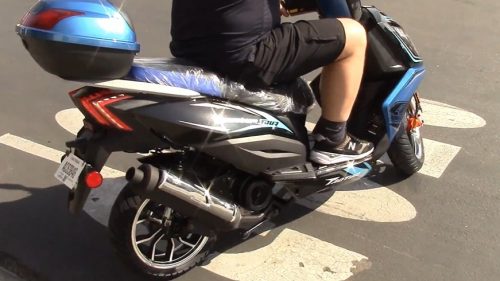 person riding 150 cc scooter